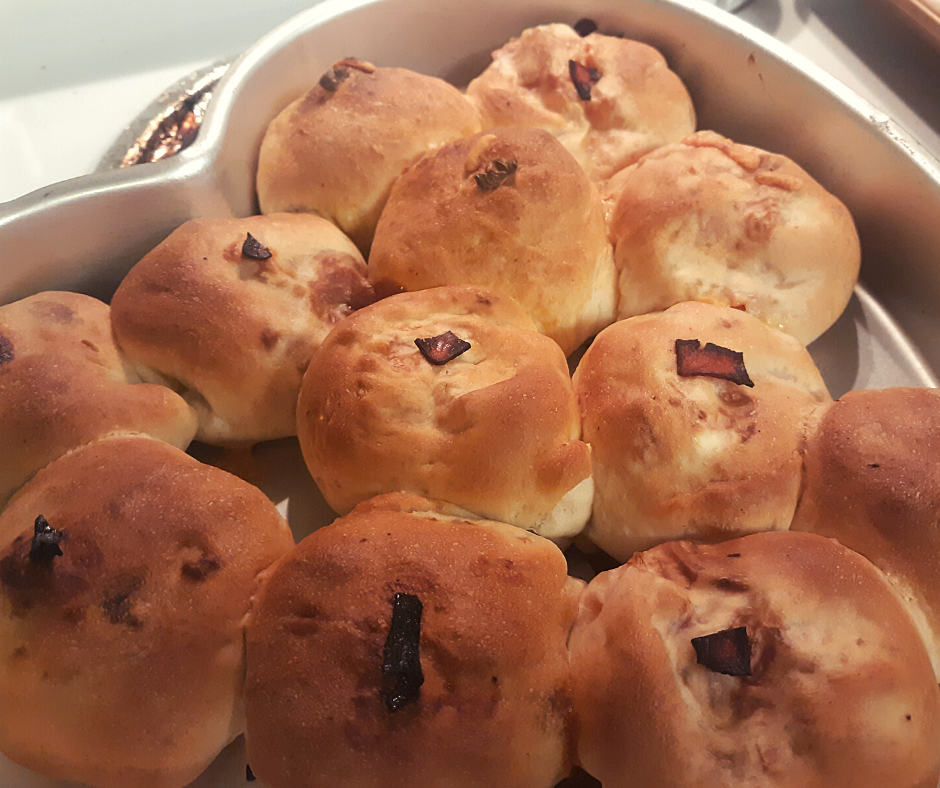 a pan of baked ham and cheese stuffed rolls