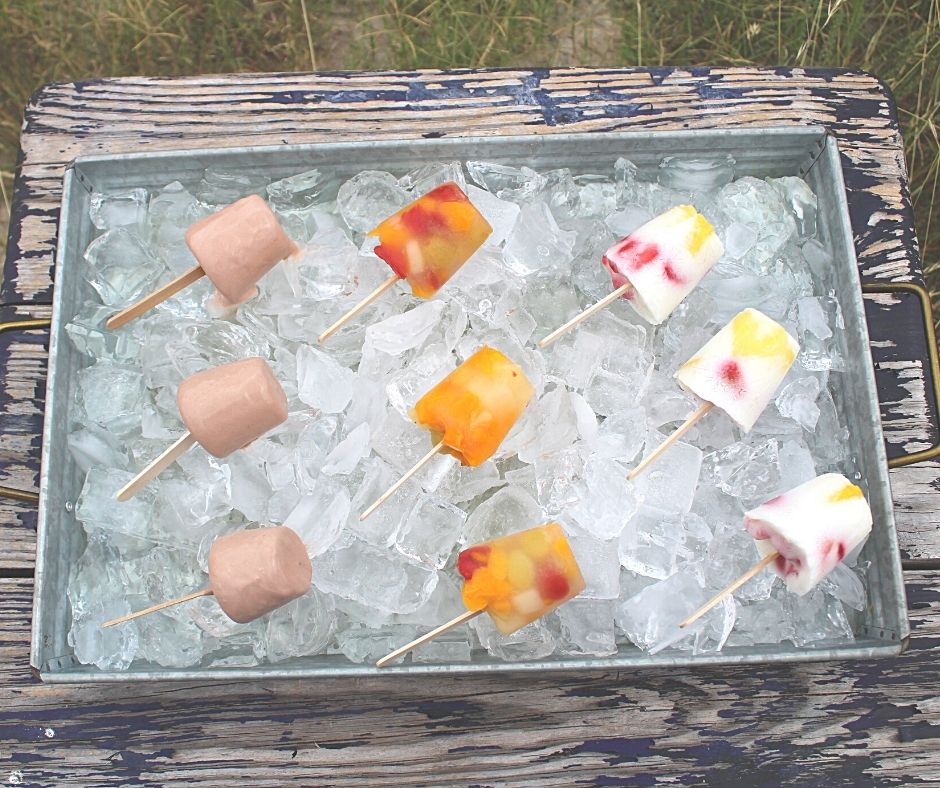 three kinds of freezer pops on ice. chocolate, cherry fruit, and yogurt and fruit.