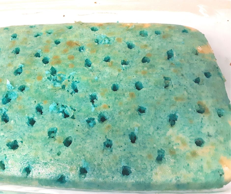 a blue poke cake with just the cake and jello. there are holes in the top of the cake.