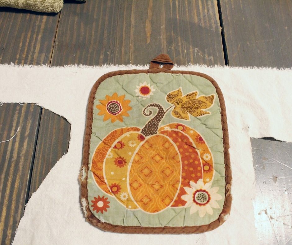 tracing a potholder onto bleached drop cloth