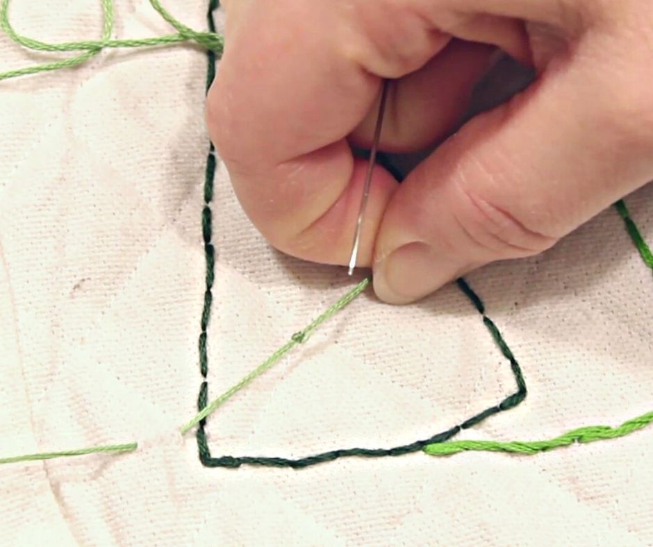 showing the knot while embroidering a drop cloth potholder