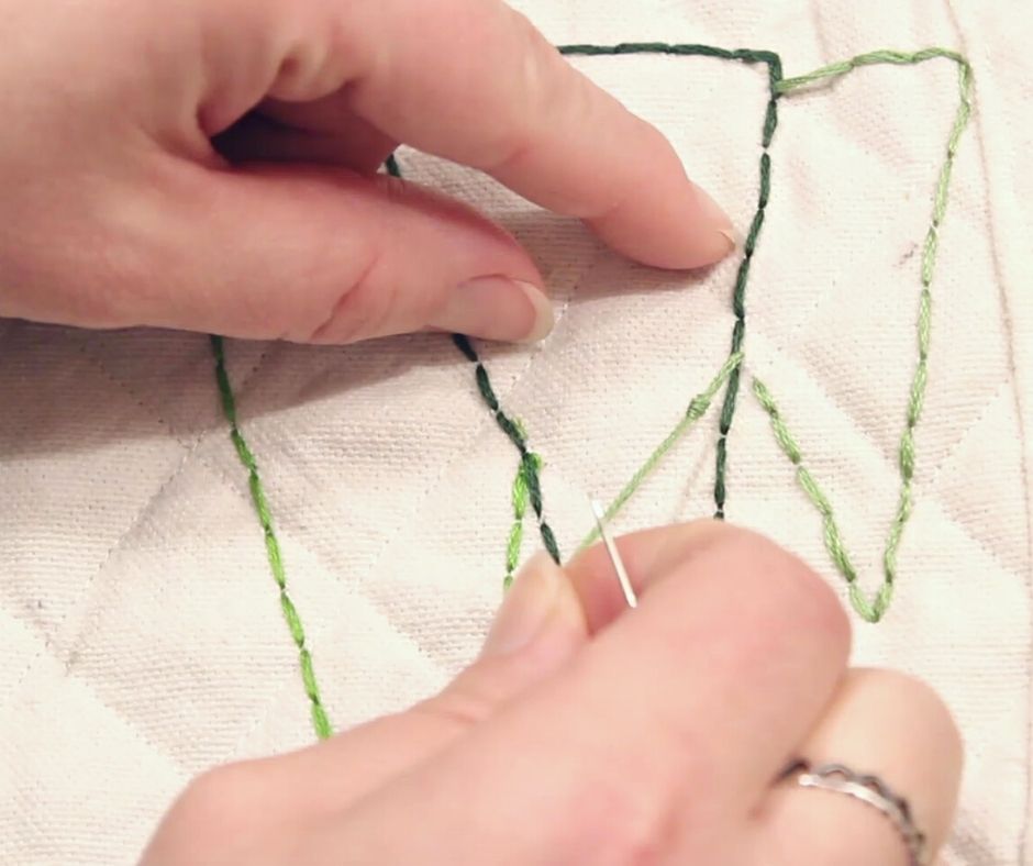 showing the knot of stitching on a drop cloth potholder