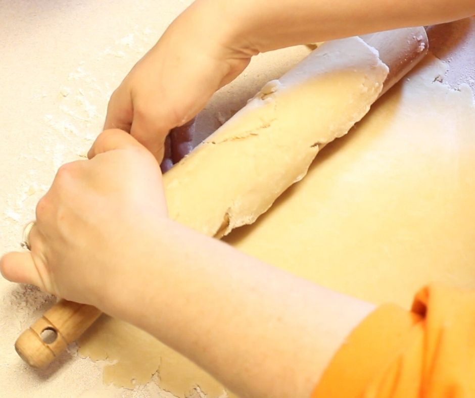 easy pie crust being rolled onto a rolling pin