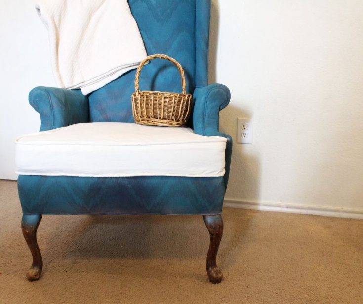 white bleached drop cloth cushion cover on blue arm chair