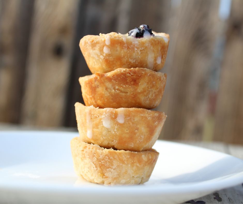 four mulberry tarts stacked on top of each other