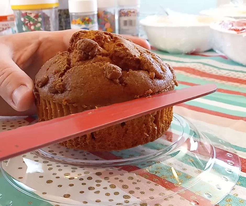 a red knife cutting off the top of a pumpkin muffin for the Costco muffin hack