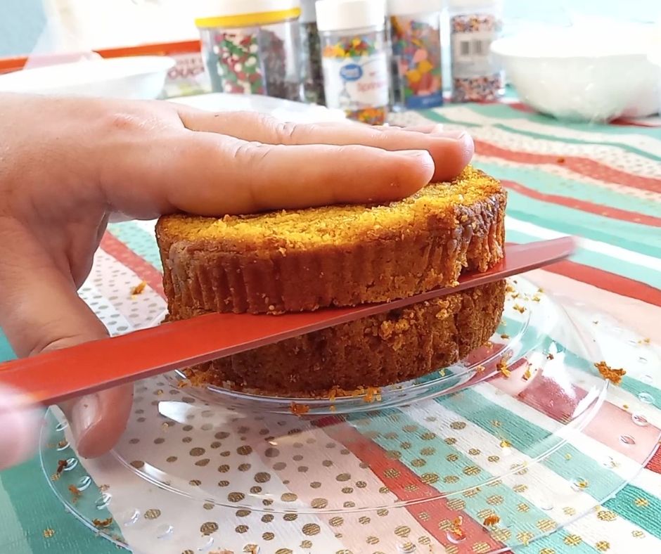 a red knife cutting into a pumpkin muffin for the Costco muffin hack